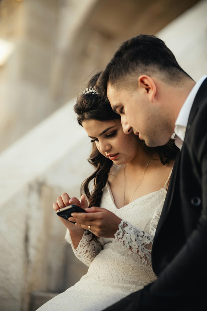 Wedding couple looking at phone